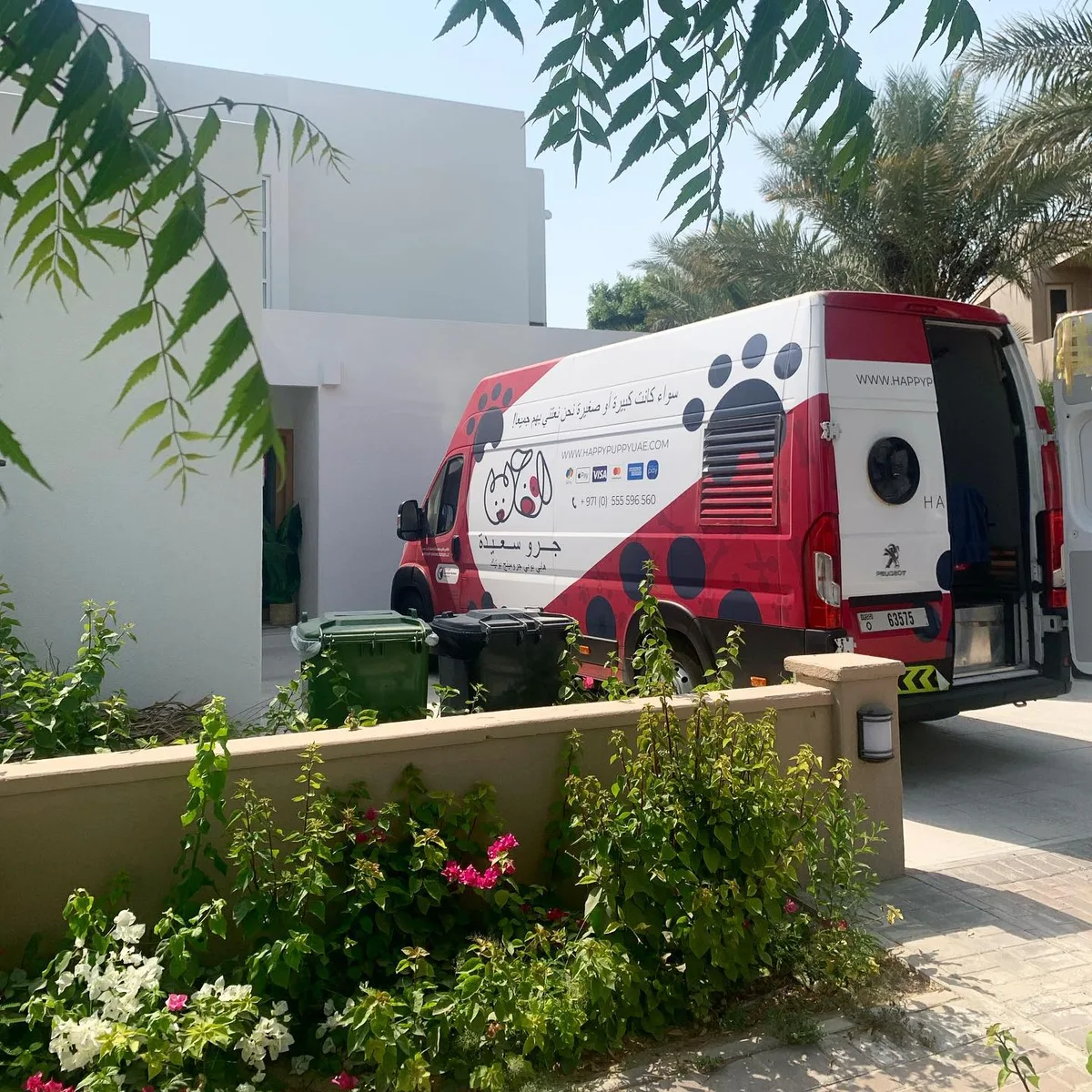 Happy Puppy grooming van parked on a villa driveway in Dubai